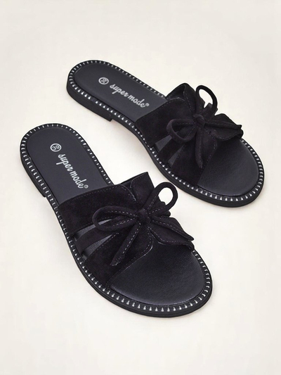 Women's flat slide sandals with a bow.