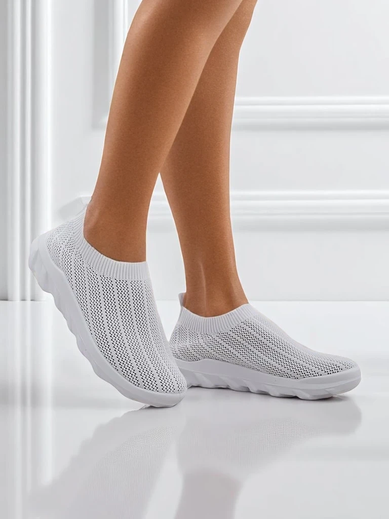 Women's white Astrea sneakers made of breathable fabric on a flat sole