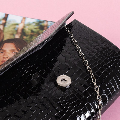 Black women's clutch bag on a chain with embossing - Handbags