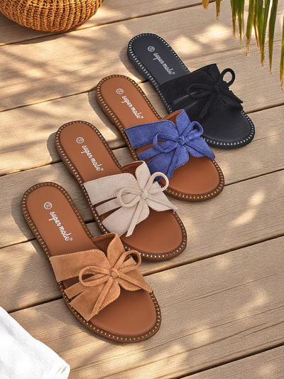 Women's flat slide sandals with a bow.