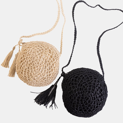 Small round handbag made of beige braided straw - Handbags