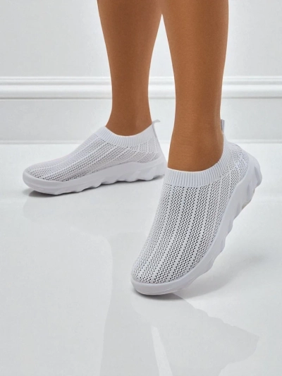 Women's white Astrea sneakers made of breathable fabric on a flat sole