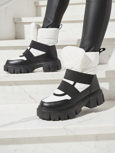 Sieviešu sniega zābaki ar plakanu zoli melnā un baltā krāsā Ferory- Footwear