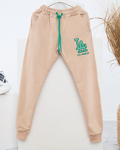 Women's beige sweatpants with a colored patch - Clothing
