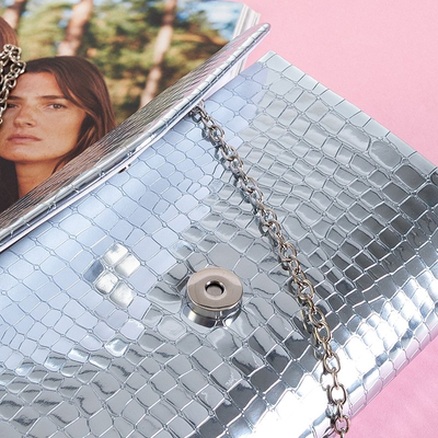 Silver women's clutch bag on a chain with embossing - Handbags