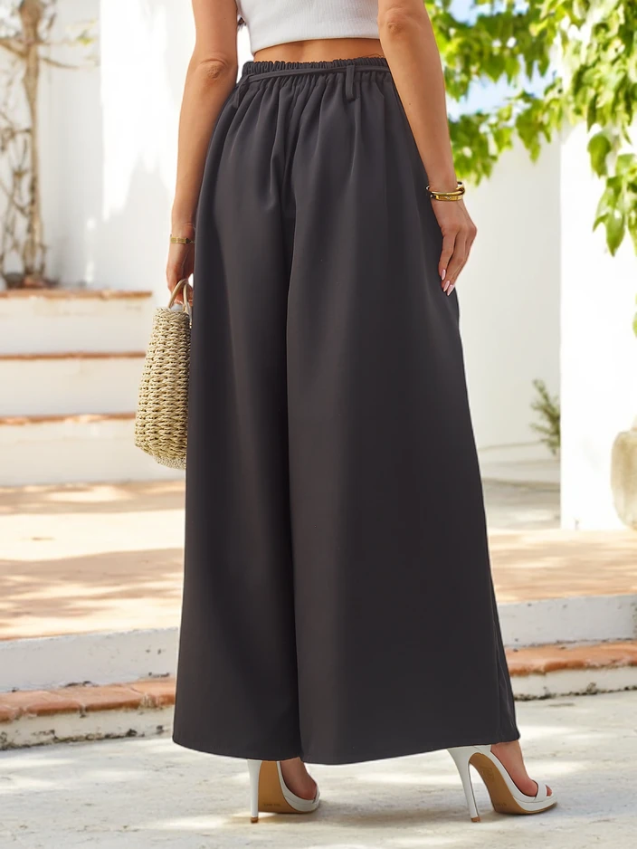 Royalfashion Elegantas platās sieviešu bikses ar dekoratīvu ziedu uz jostas