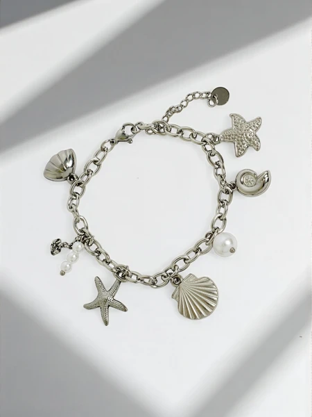 Asteria Mare pulsera ku pendientenan di plata inspirá pa laman