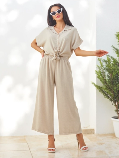 Royalfashion Sieviešu komplekts ar sasietu īsām piedurknēm un platām biksēm ar akmens izšuvumiem