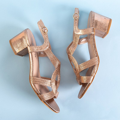 Gold women's sandals on a Madurai post - Footwear